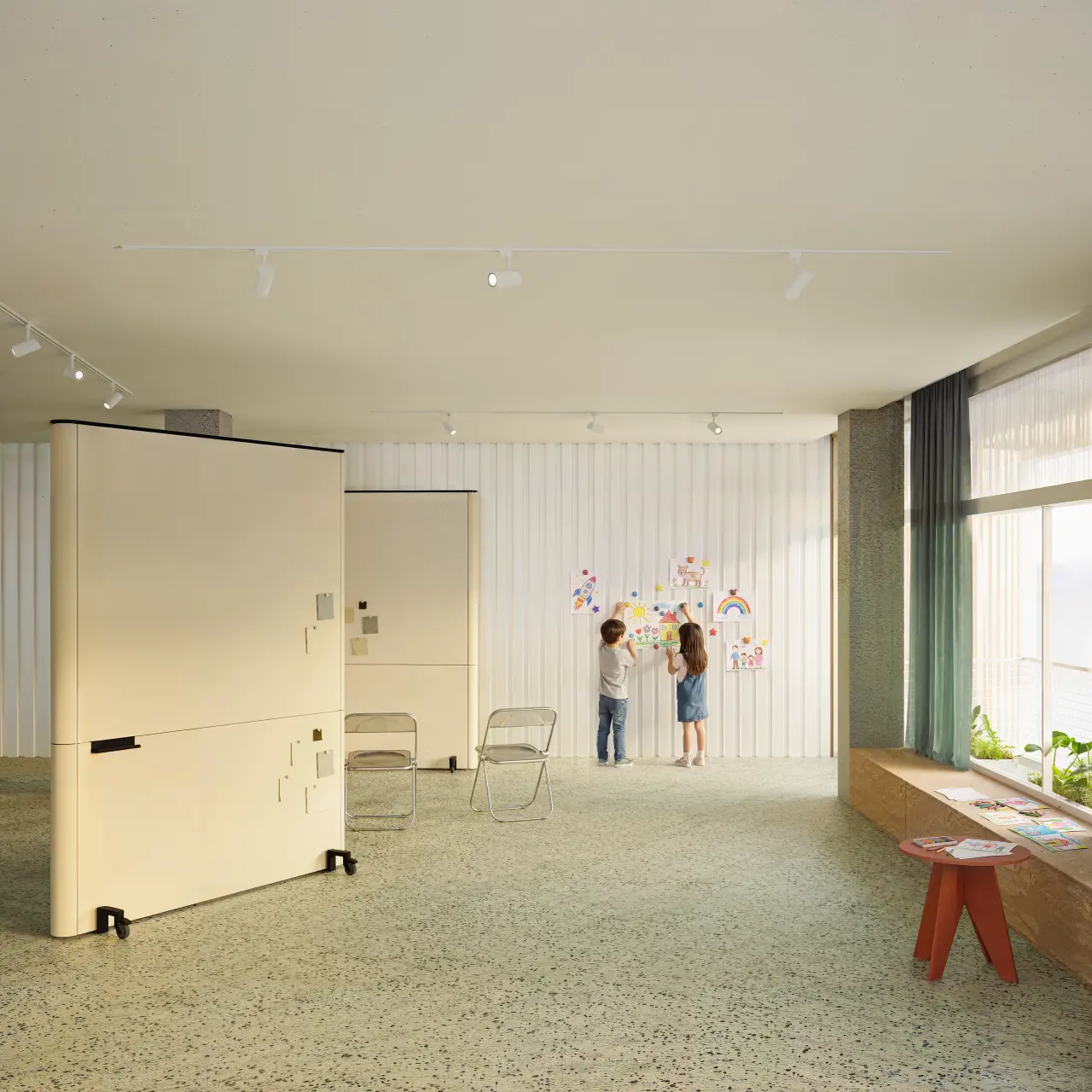 Interior of a multipurpose room, with movable partitions, folding chairs and two children pinning drawings to the wall.