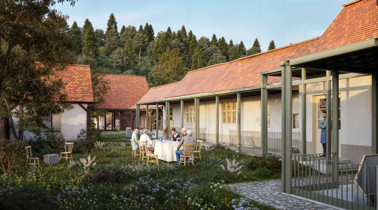 Render of the restored farmstead courtyard, with a continuous porch along the outbuildings' façade and people seated at a table in the garden.